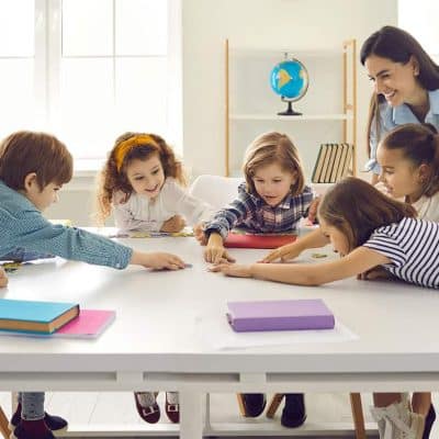 teachers with kids doing activity inside classroom